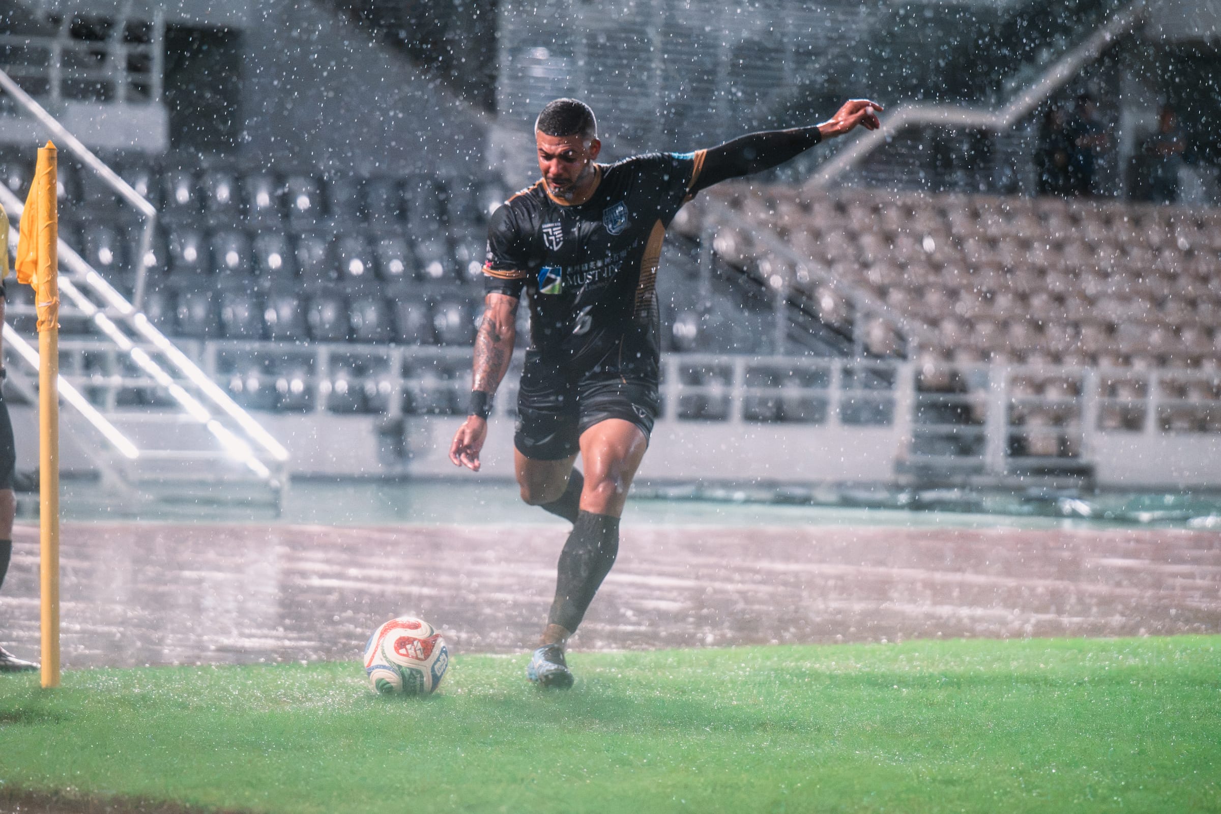 MUST IPO senior player taking a corner in heavy rain